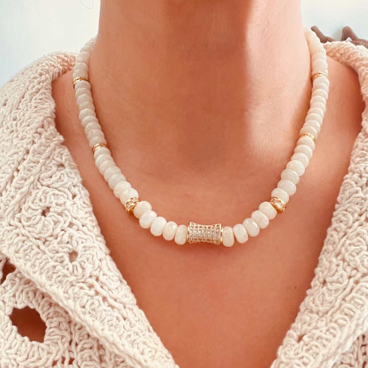 Ivory Jade Bloom beaded Necklace with a textured gold center accent, paired with a cream crochet top.