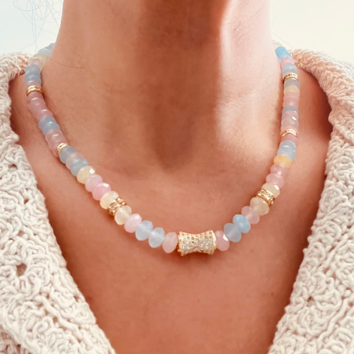 Delicate Morganite beaded necklace with pastel blue, pink, and yellow beads, accented by small gold spacer beads and a central gold cylindrical charm.